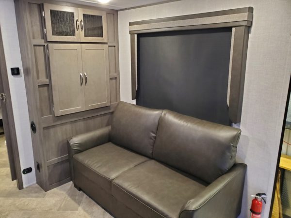Couch inside the 2021 Alta Travel Trailers 2350-KRK Rear Kitchen