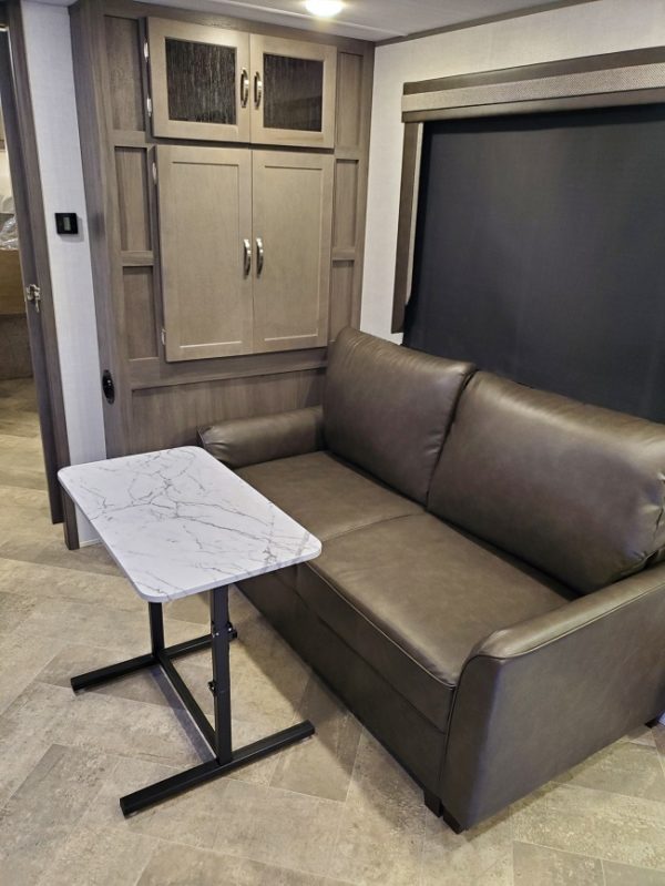 Couch and table in the 2021 Alta Travel Trailers 2350-KRK Rear Kitchen