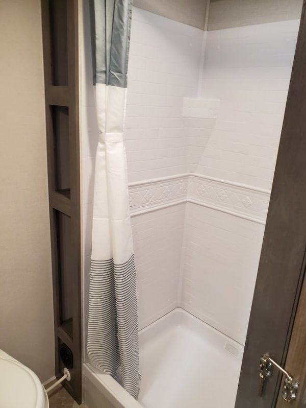 View of the stand up shower inside the 2021 Alta Travel Trailers 2600-KRB Rear Bath