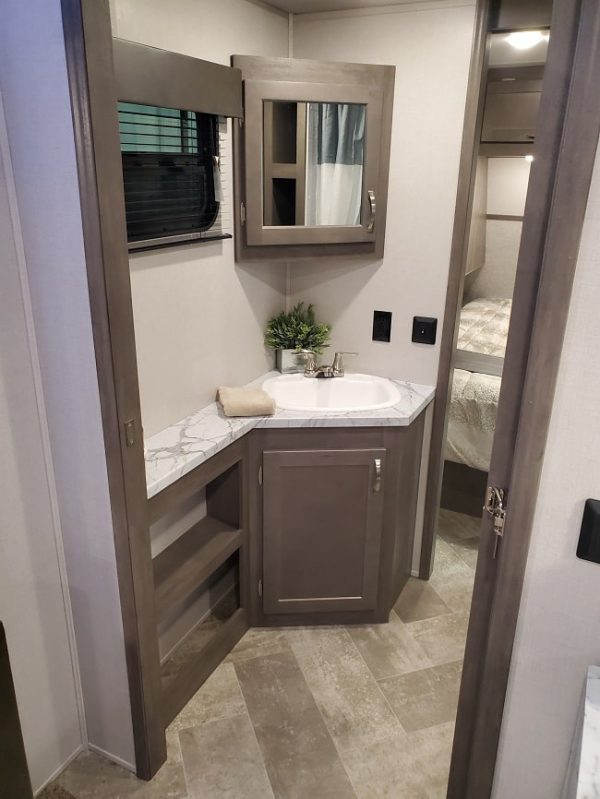 View of the bathroom suite inside the 2021 Alta Travel Trailers 2850-KRL