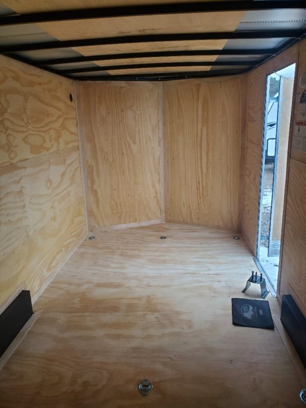 View of the man-door from the inside of the 2022 Cargo Mate 7x16 (Black)