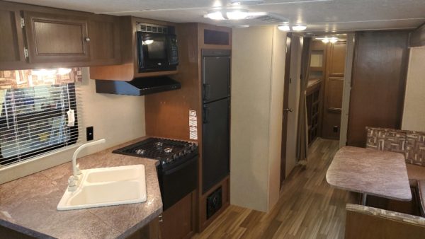 Fridge and cabinets in the kitchen of the 2017 Shasta 310K Bunk House
