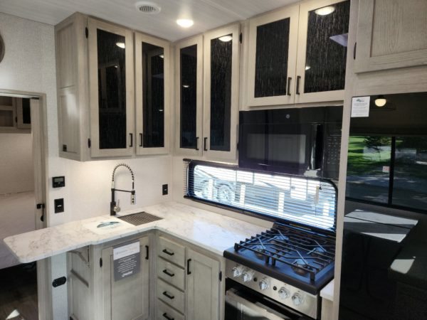 Fold out cutting board and L-shaped countertops in the 2023 Alta 3100KXT Xtreme 365