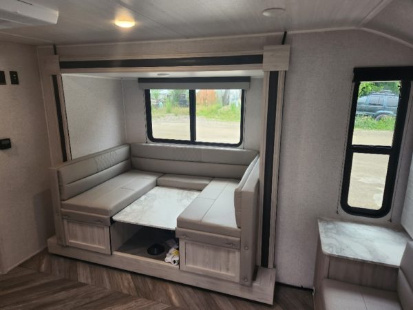 View of the dinette and slide inside of the 2023 Della Terra 175BHLE Bunk House