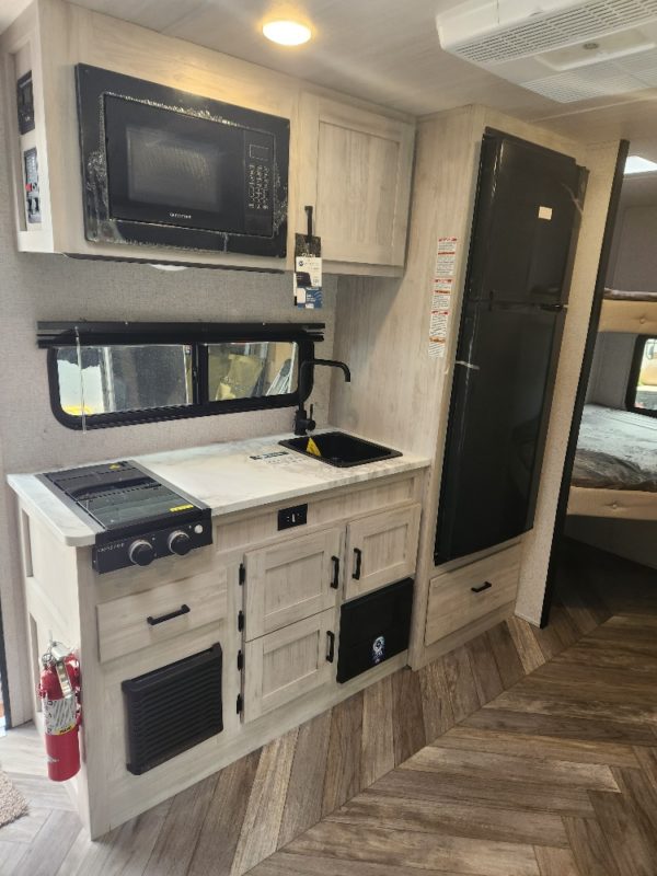 View of the functional kitchen inside of the 2023 Della Terra 175BHLE Bunk House