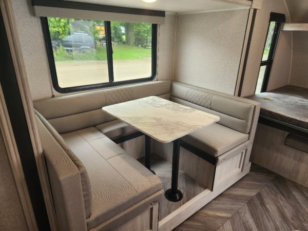 View of the dinette and slide extended inside the 2023 Della Terra 175BHLE Bunk House